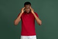 Stressed young african american man feel pain and having terrible strong headache concept. Tired upset guy massaging Royalty Free Stock Photo