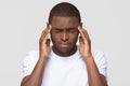 Stressed young african american man feeling pain having terrible headache Royalty Free Stock Photo