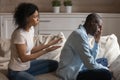 Stressed young african ethnicity woman apologizing to offended husband. Royalty Free Stock Photo