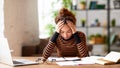 Stressed young afro american female feeling tired while working remotely or studying online at home Royalty Free Stock Photo