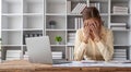 Stressed young Asian businesswoman focuses on rechecking the business financial investment plan& x27;s report at her desk Royalty Free Stock Photo