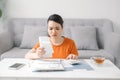 Stressed young asian woman holding so many expenses bills in her hand no money to pay debt Royalty Free Stock Photo