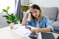 Stressed young asian woman with monthly bill expenses and credit card debt at home Royalty Free Stock Photo