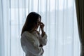 Stressed young Asian woman suffering on depression and standing alone in dark room at home. sad, unhappy, disappointed concept Royalty Free Stock Photo