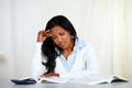 Stressed young black woman reading a book