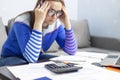 Stressed young brunet woman sits at home manage household finances frustrated with family financial problems. Distressed upset Royalty Free Stock Photo