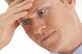 Stressed young businessman with hand on forehead Royalty Free Stock Photo