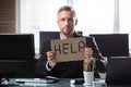 Businessman Holding Cardboard With Help Text