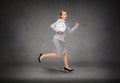 Stressed young businesswoman with clock running Royalty Free Stock Photo