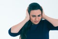 Frustrated and stressed young businesswoman closed her ears isolated on white background. Royalty Free Stock Photo