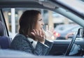 Stressed young businesswoman driving her car Royalty Free Stock Photo