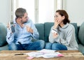 Stressed young couple having an argument over credit car debts payments and home finance Royalty Free Stock Photo