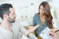 Stressed young couple quarrel at psychologist