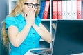 Stressed young girl in front of a computer screen. She accidentally deleted files.