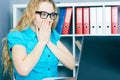 Stressed young girl in front of a computer screen. She accidentally deleted files.