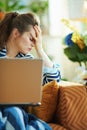 Stressed woman with laptop at modern home in sunny day Royalty Free Stock Photo