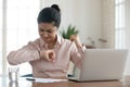 Unhappy millennial woman checking time to workday finish. Royalty Free Stock Photo