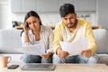 Stressed young indian spouses checking financial papers at home Royalty Free Stock Photo