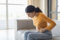 Stressed young indian woman touching her stomach, suffering acute abdominal pain Royalty Free Stock Photo