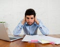 Stressed young man paying bills trying to manage home and business finances Royalty Free Stock Photo