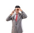 stressed young man wearing suit hold his head while making a phone Royalty Free Stock Photo