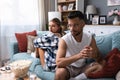 Stressed young married couple sitting separately on different sides of sofa ignoring each other after quarrel. Offended spouses Royalty Free Stock Photo