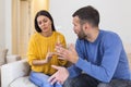 Stressed young married family couple arguing emotionally, blaming lecturing each other, sitting on couch. Depressed husband Royalty Free Stock Photo