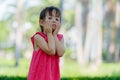 Stressed young multi ethnic girl looking bored and tired at the park outdoors