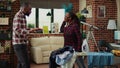 Stressed young person ironing laundered apparel