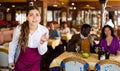 Stressed young waitress fed up with work standing in restaurant Royalty Free Stock Photo