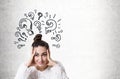 Stressed young woman with a bun, question marks Royalty Free Stock Photo