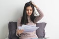 Stressed young woman calculating monthly expense and checking credit card bills invoice Royalty Free Stock Photo