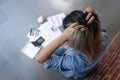 Stressed young woman calculating monthly home expenses with bank account balance and credit card bills Royalty Free Stock Photo