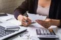 Stressed young woman checking bills, taxes, bank account balance and calculating expenses in the living room Royalty Free Stock Photo