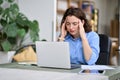 Stressed young woman employee touching head feeling headache fatigue at work. Royalty Free Stock Photo