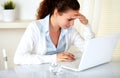 Stressed young woman reading on laptop screen Royalty Free Stock Photo