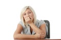 Stressed young woman sitting behind a desk Royalty Free Stock Photo