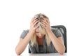 Stressed young woman sitting behind a desk Royalty Free Stock Photo