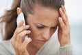 Stressed young woman in sweater on beach talking cell phone Royalty Free Stock Photo