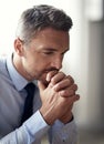 The stresses of work. a mature businessman looking anxious while working in his office. Royalty Free Stock Photo