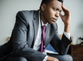 A stressful black man sitting Royalty Free Stock Photo