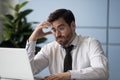 Stressful businessman getting bad news looking at screen laptop.