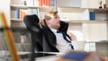 Stressful Caucasian businessman looking pensive and thoughtful at his deck in the office with selective focus, concept failure of