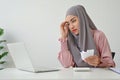 A stressful muslim woman feeling stressed and confused by calculate expense from invoice Royalty Free Stock Photo