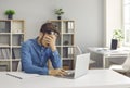 Stressed, tired, exhausted man who has burnout sitting at office desk with laptop Royalty Free Stock Photo