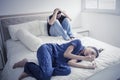 Stressful teenage couple with pregnancy test on bed Royalty Free Stock Photo