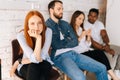 Stressful tired young diverse multi-ethnic vacancy applicant waiting job interview with hr, sitting in queue line row on Royalty Free Stock Photo