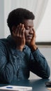 Stressing african american man with big headache pain, suffering from migraine, rubbing his temples Royalty Free Stock Photo