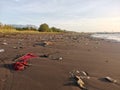 A stretch of beach sand polluted by piles of garbage Royalty Free Stock Photo