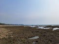 a stretch of coral rocks on the edge of a beautiful beach